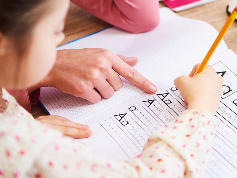 Girl writing on worksheet