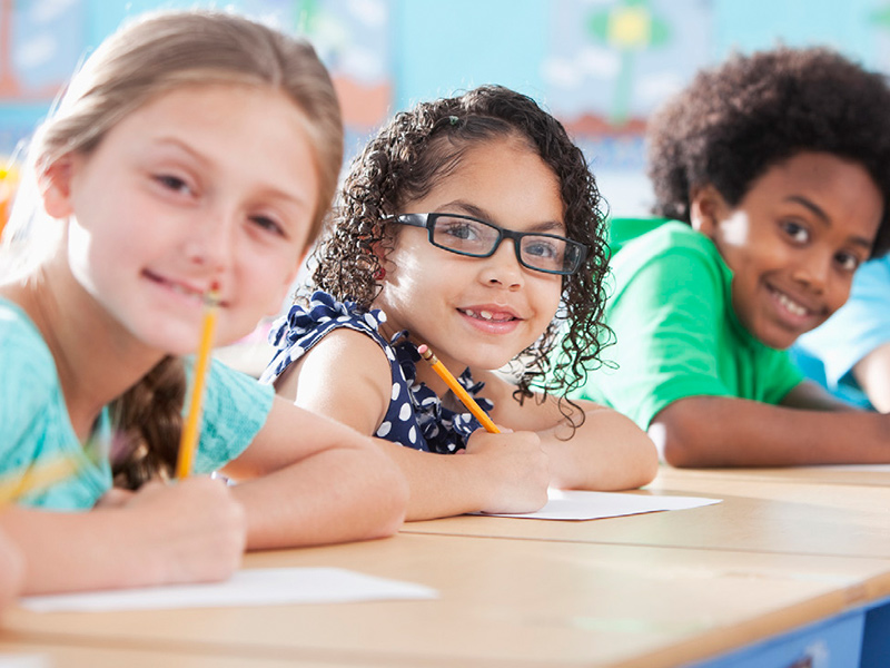 Students writing at desks