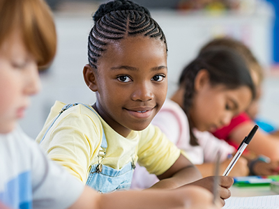 SUTW - Girl writing in classroom