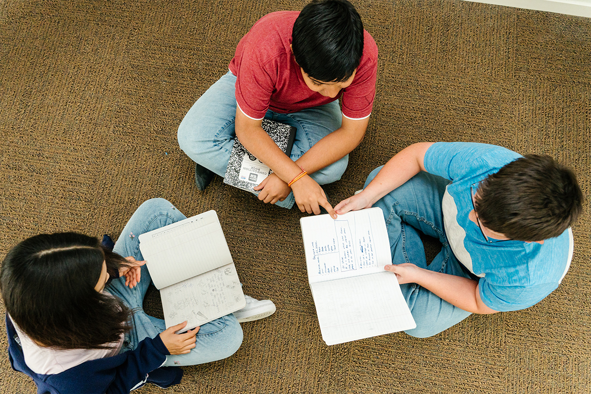 3 students discussing notes