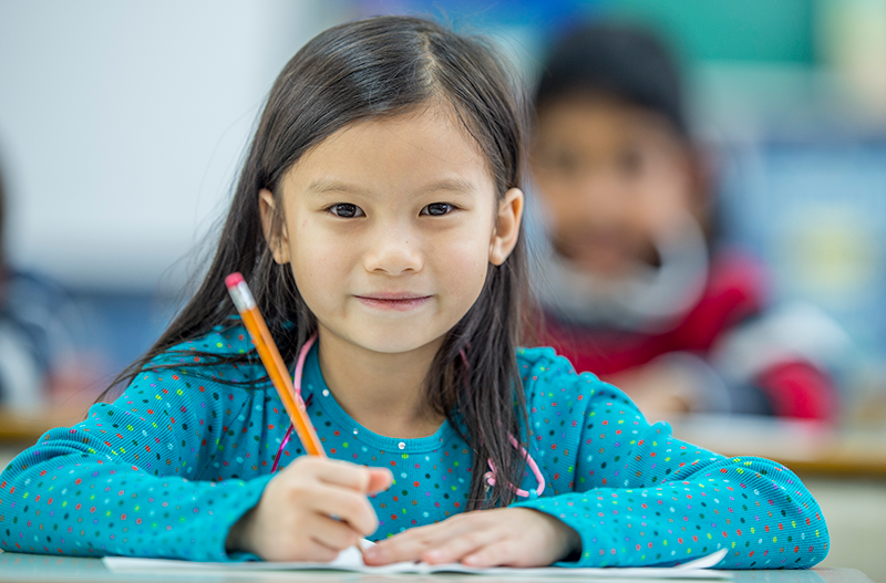 Girl writing at desk