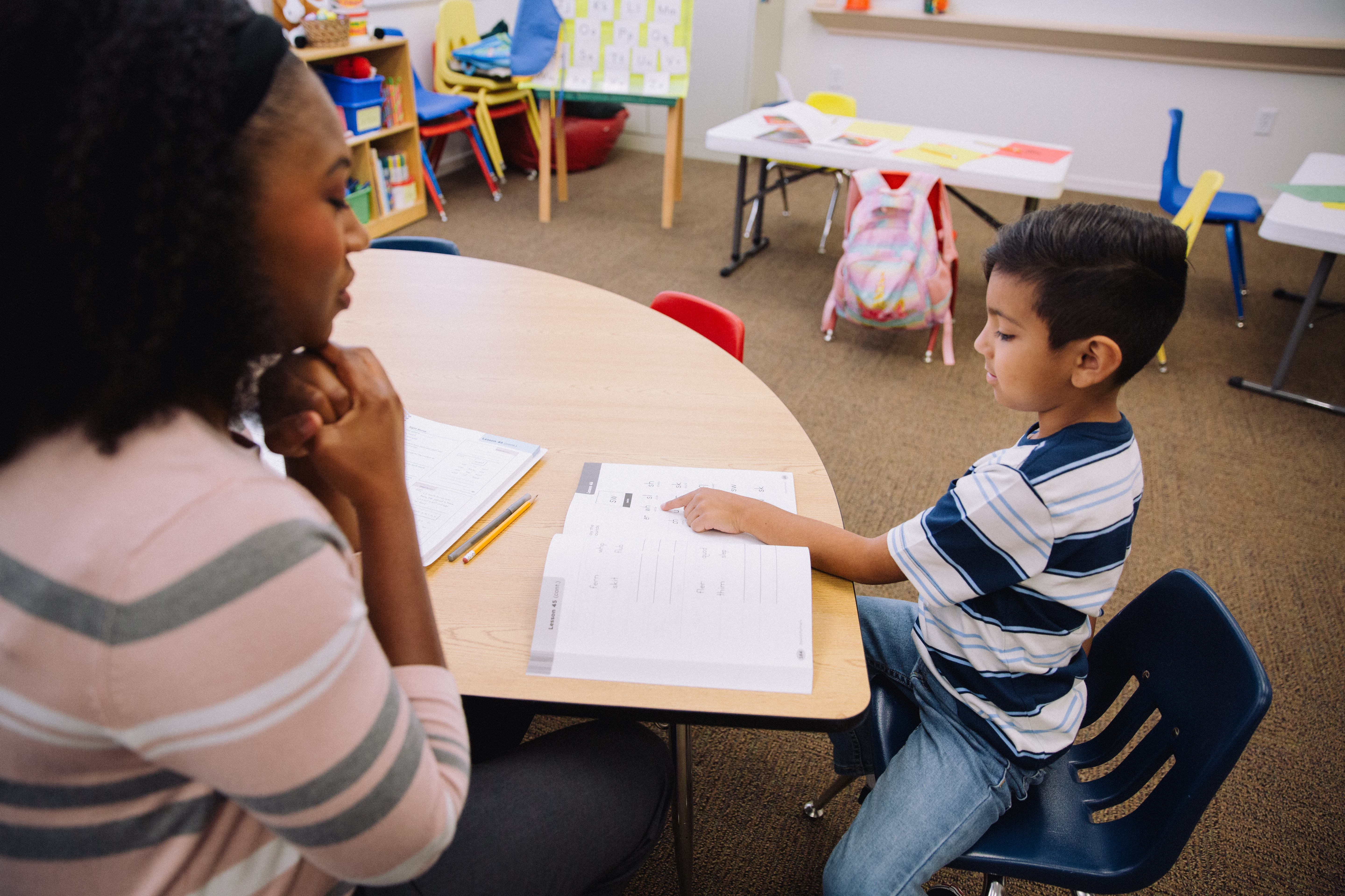 Teacher and student going through workbook