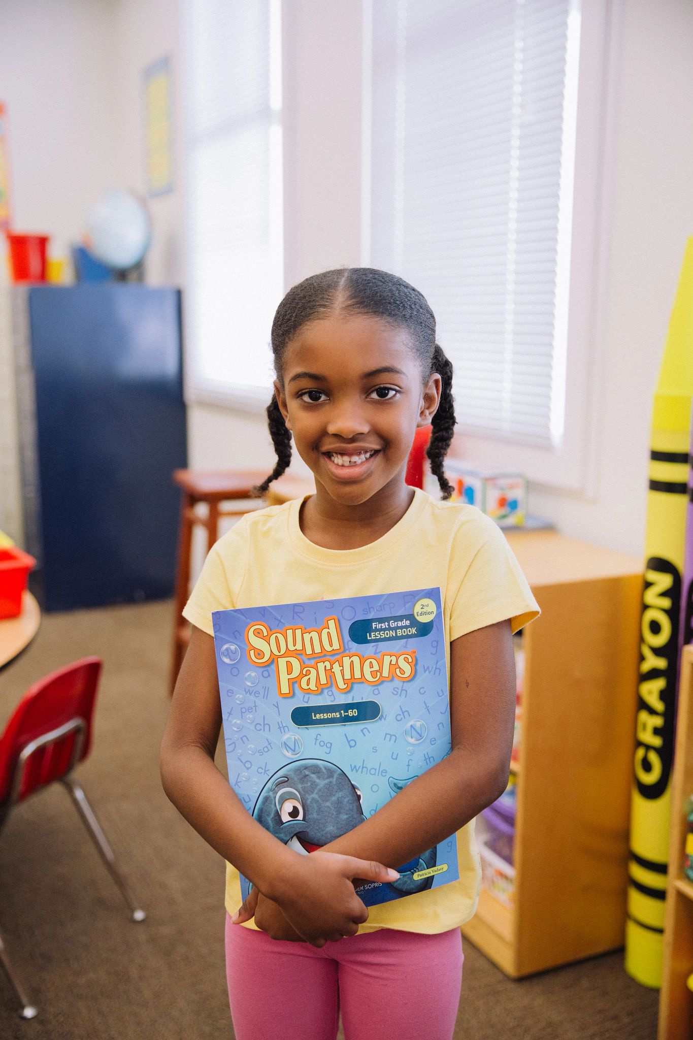 Student Holding Sound Partners Book