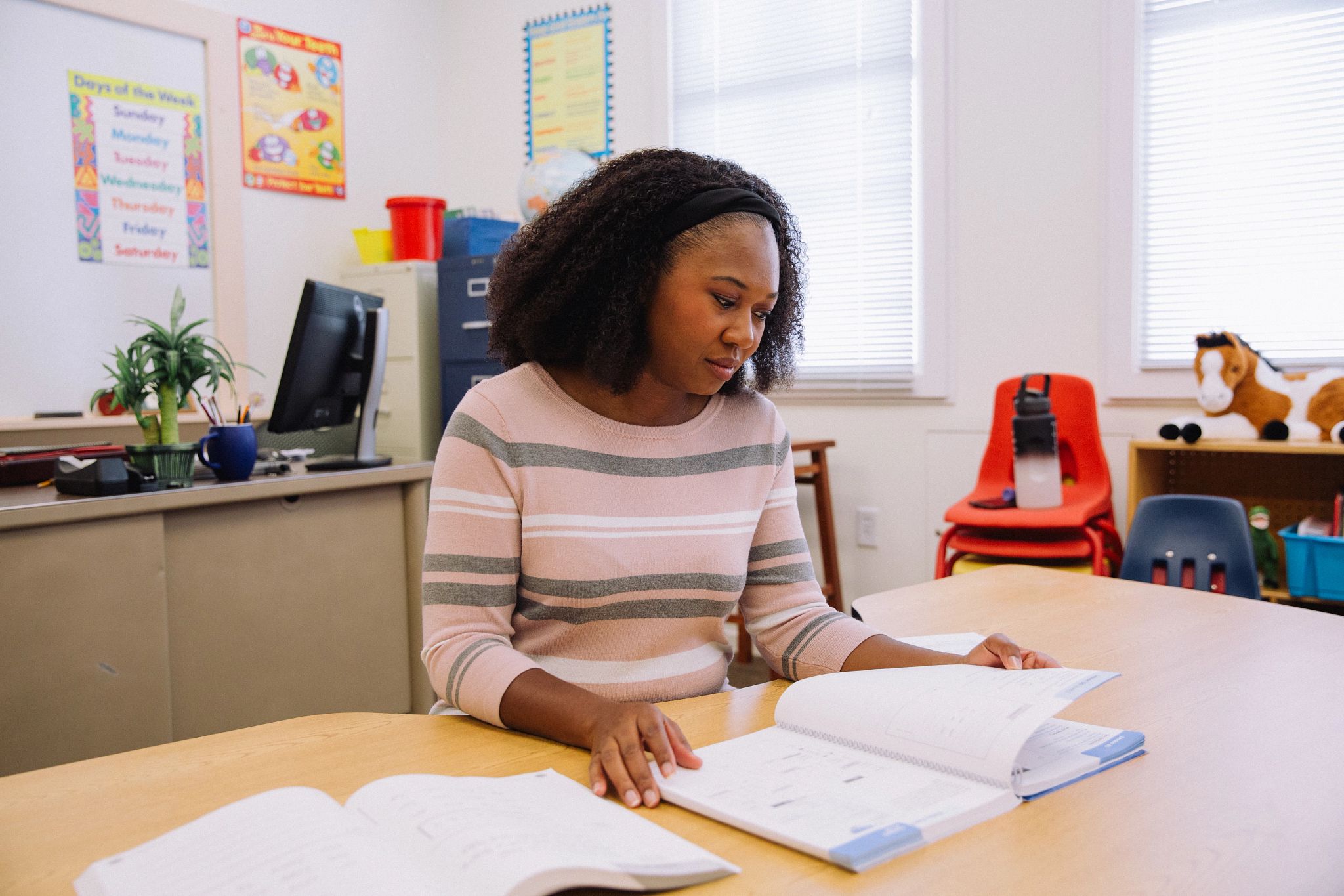 Teacher Reading at Desk